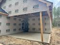 Covered patio with unfinished construction featuring wood beams and concrete flooring at 214 Green Pines Estates Dr, Kenly, NC 27542