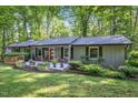 Charming single-story home with a inviting front porch and a beautifully landscaped yard and pretty planters at 220 Cardinal Dr, Youngsville, NC 27596