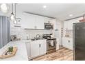 Bright kitchen with stainless steel appliances, subway tile backsplash and white cabinetry at 2746 Saint Lukes Church Rd, Goldston, NC 27252