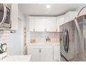 Bright kitchen featuring stainless steel appliances and white subway tile backsplash at 2746 Saint Lukes Church Rd, Goldston, NC 27252