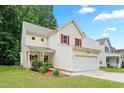 Charming two-story home featuring a 2-car garage, landscaped front yard and covered porch at 3223 Polite Ln, Raleigh, NC 27610