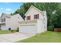 Side view of a two-story home with an attached two-car garage and driveway at 3223 Polite Ln, Raleigh, NC 27610