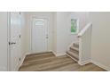 Bright entryway with hardwood floors, a stairway, a coat closet and decorative door glass at 3223 Polite Ln, Raleigh, NC 27610