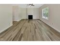 Spacious living room with hardwood flooring, a fireplace, neutral paint, and lots of natural light at 3223 Polite Ln, Raleigh, NC 27610