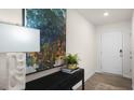 Inviting entryway with a decorative table, lamp, large modern art, and direct access to the main living areas at 3608 Sorda Ct, Raleigh, NC 27610