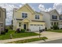 Charming yellow two-story home features a well-maintained lawn, a two-car garage, and inviting curb appeal at 4024 Dunkirk Dr, Burlington, NC 27215