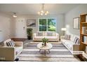 Bright living room featuring modern furniture, a cozy rug, and lots of natural light at 4126 Amber Stone Way, Durham, NC 27704