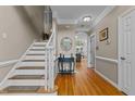 Inviting entryway showcasing hardwood floors, staircase, and elegant decor at 4225 Old Lewis Farm Rd, Raleigh, NC 27604