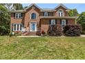 Beautiful brick home with a well-maintained lawn and classic architectural details at 4225 Old Lewis Farm Rd, Raleigh, NC 27604