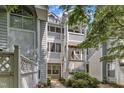 Exterior angle shot of a multi-story apartment building with latticed balconies and well maintained landscaping at 4907 Hollenden Dr # 106, Raleigh, NC 27616