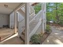 Exterior staircase of an apartment building with latticed railings, and green foliage at 4907 Hollenden Dr # 106, Raleigh, NC 27616