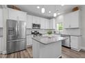 Modern kitchen with granite countertops, stainless steel appliances, and white cabinetry at 5 Cinnamon Teal Way, Youngsville, NC 27596