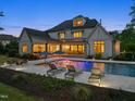 Relax in style by the pool, complete with lounge chairs, outdoor dining, and lush landscaping at 5125 Avalaire Oaks Dr, Raleigh, NC 27614