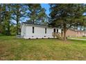 A charming home displays well-kept vinyl siding and an expansive yard, complemented by mature trees at 623 Lincoln Dr, Kenly, NC 27542