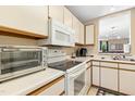 Well-lit kitchen with white cabinetry, laminate countertops, and modern appliances at 700 Martin Luther King Jr Blvd # A6, Chapel Hill, NC 27514