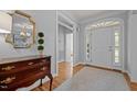 Bright foyer features hardwood floors, chandelier, decorative mirror, and arched doorway at 708 Mill Pointe Way, Elon, NC 27244
