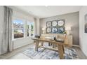 Bright home office with a wooden desk, stylish rug, and decorative wall mirrors at 729 Deschutes Dr, Garner, NC 27529