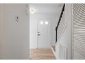Bright entryway featuring hardwood floors, white walls, and a staircase at 8004 Mill Bluff Ct, Raleigh, NC 27616