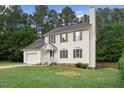 Inviting two-story home with a well-maintained lawn and classic architectural details at 8004 Mill Bluff Ct, Raleigh, NC 27616