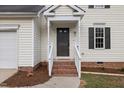 Close-up of the front door with brick steps leading to a covered entryway at 8004 Mill Bluff Ct, Raleigh, NC 27616
