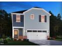 Charming two-story home with a two-car garage, stylish shutters, and a cozy front porch at 805 Ottawa Dr, Garner, NC 27529