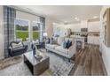 Bright living room with hardwood floors, modern furnishings, and a view of the outdoors at 805 Ottawa Dr, Garner, NC 27529
