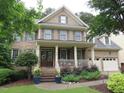 Charming brick home with a well-manicured lawn and inviting front porch at 1021 Golden Star Way, Wake Forest, NC 27587
