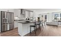 Modern kitchen with white cabinets, stainless steel appliances, dark countertops and bar stool seating at 10514 Pleasant Branch Dr # 35, Raleigh, NC 27614