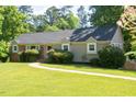 Charming home features manicured bushes and an inviting walkway at 106 Chariot Dr, Sanford, NC 27330