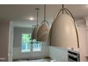 Dining room with modern pendant lights and large windows offering serene views at 118 Sanderway Dr, Chapel Hill, NC 27516