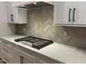 Modern kitchen showcasing white cabinetry, stylish hardware, quartz countertops, and a gas range at 118 Sanderway Dr, Chapel Hill, NC 27516