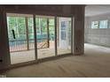 Spacious room with wall paneling that leads to a screened porch with outdoor views at 118 Sanderway Dr, Chapel Hill, NC 27516