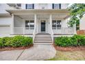 Inviting front porch with classic white columns and wood railing, perfect for relaxing at 120 Hatchet Creek Ct Ct, Morrisville, NC 27560