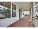Spacious porch view featuring a wood floor, white columns and exterior trim at 120 Hatchet Creek Ct Ct, Morrisville, NC 27560