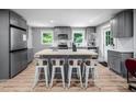 Modern kitchen featuring an island with seating for four and stainless appliances at 1402 Robinhood Rd, Durham, NC 27701
