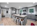 Modern eat-in kitchen boasts stainless steel appliances and butcher block island with bar stool seating at 1402 Robinhood Rd, Durham, NC 27701