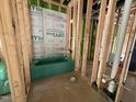 Framed bathroom under construction with a green tub installed and plumbing visible at 1521 1/2 Sunrise Ave, Raleigh, NC 27608