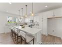 Modern kitchen with white cabinets, quartz countertops, and stainless steel appliances at 169 Nashua Dr # 2590P, Louisburg, NC 27549