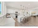 Well-lit kitchen with a large island, modern appliances, and ample counter space at 169 Nashua Dr # 2590P, Louisburg, NC 27549