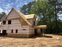 A partially constructed home shows a covered porch area with exposed framing and the home surrounded by trees at 194 Landon Ridge, Sanford, NC 27330