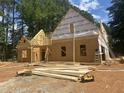 New home construction showcasing the framed structure with building materials scattered on the lot at 194 Landon Ridge, Sanford, NC 27330