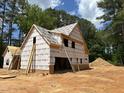 A partially constructed home shows exposed framing with a ladder leaning against it and a pile of dirt in the background at 194 Landon Ridge, Sanford, NC 27330