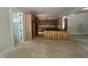 Open kitchen with wooden cabinets, island and abundant natural light from windows at 194 Landon Ridge, Sanford, NC 27330