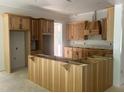 Spacious kitchen with wooden cabinets and a large center island awaiting countertops at 194 Landon Ridge, Sanford, NC 27330