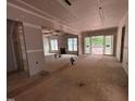 Unfinished living room area with natural light, drywall, exposed beams and sliding doors to outdoor space at 194 Landon Ridge, Sanford, NC 27330