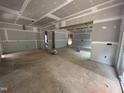 Unfinished living room featuring drywall, exposed beams, and concrete flooring, ready for customization at 194 Landon Ridge, Sanford, NC 27330
