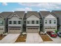 An aerial view showcases three townhomes, highlighting their design, curb appeal, and landscaping at 2140 Stegemann St, Apex, NC 27502