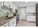 Modern kitchen with stainless steel appliances, granite countertops, and ample cabinet space at 2206 Guess Rd, Durham, NC 27705