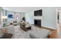Bright living room featuring a fireplace, hardwood floors, and neutral decor at 2206 Guess Rd, Durham, NC 27705