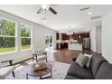 Open-concept living area with hardwood flooring seamlessly connects to the kitchen and dining space at 244 Potomac River St, Garner, NC 27529